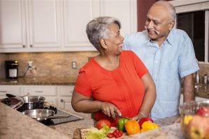 couple cooking together and looks happy