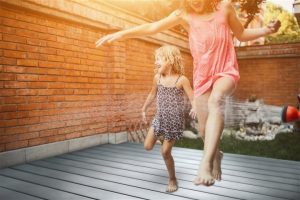mother and daughter bonding in the backyard deck